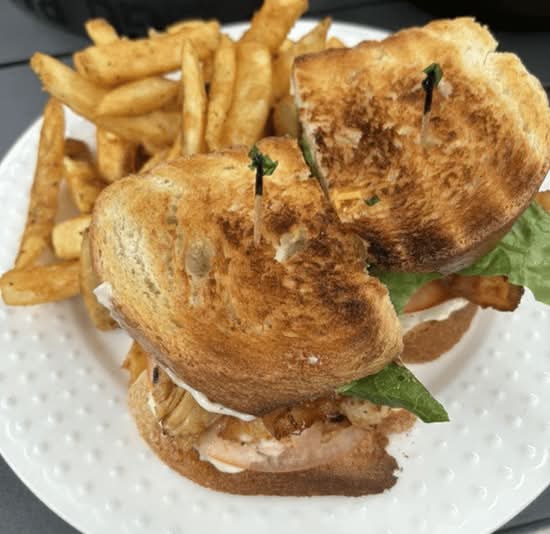 Toasted club sandwich with fries